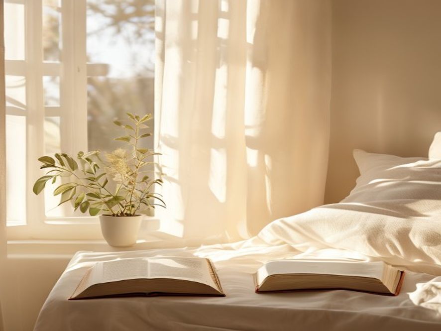 A well-organized bedroom shelf with a bedside journal, water glass, and small potted plant in morning light